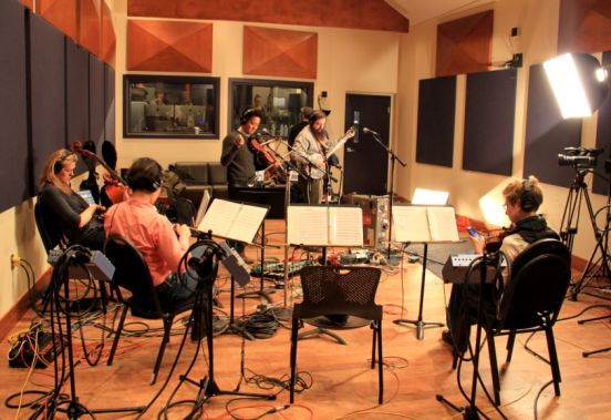 image presenting musicians in a recording studio, in a web page related to music research, music technology and the YMusic search engine