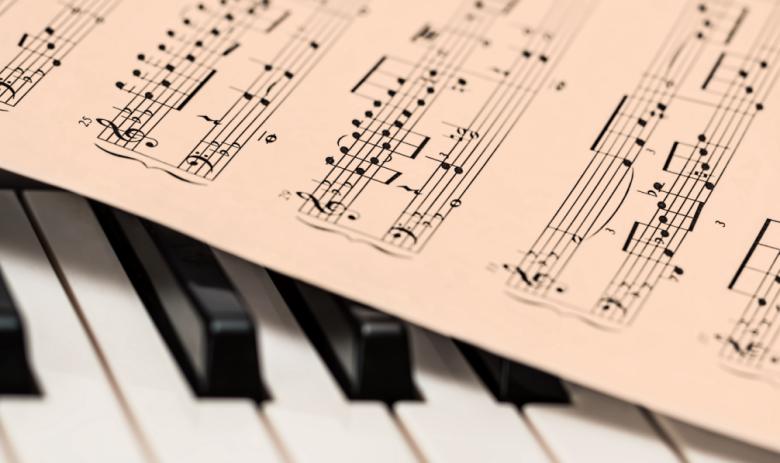 image presenting a sheet music on a piano, in a web page related to music research, music technology and the YMusic search engine
